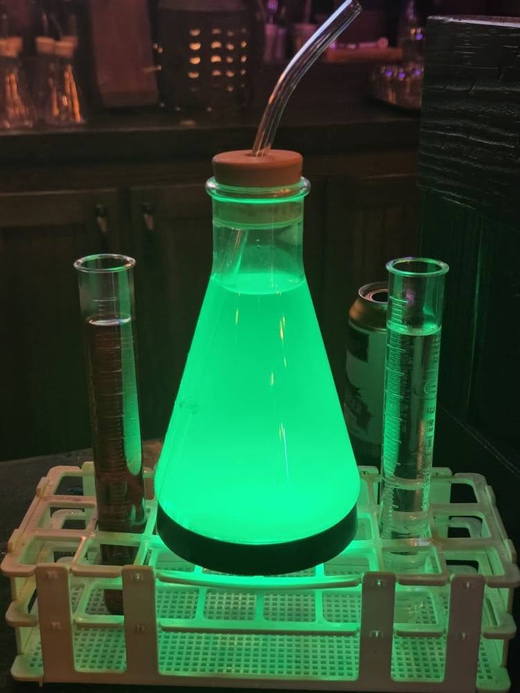 Glowing green Monocane cocktail at Burning Blade Tavern